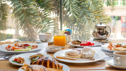Breakfast in luxury hotel. Table full of various food from buffet in modern tropical resort....