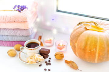 Christmas mood, a cup of coffee with sweets on a winter window under burning candles