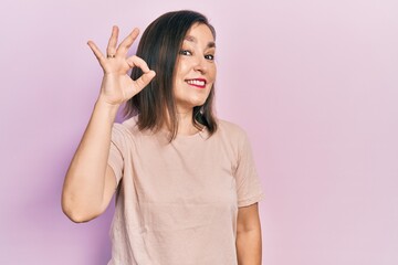 Middle age hispanic woman wearing casual clothes smiling positive doing ok sign with hand and fingers. successful expression.
