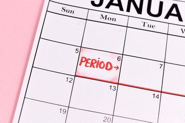 Female period concept with calendar date with period start marked with red word