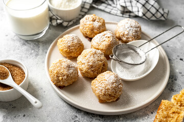 Homemade coconut cookies in a white plate on a light gray culinary background
