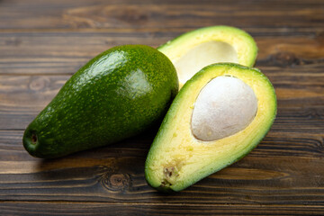 Close-up of an avocado on a wooden background. Healthy food concept.