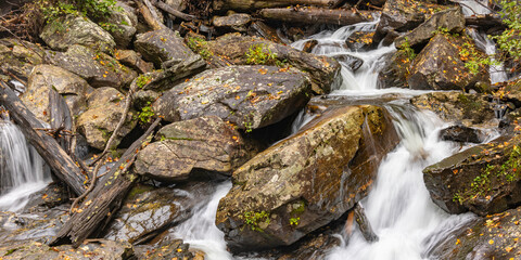 Bolders with a river flowing through in the fall.  