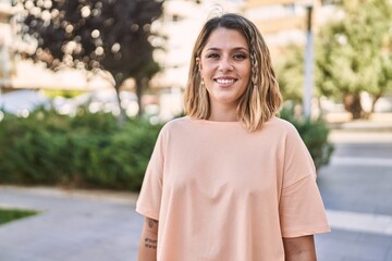 Young hispanic woman smiling confident at park