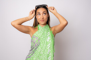 Fototapeta premium Portrait of happy young woman in summer clothing and looking side isolated over white background.