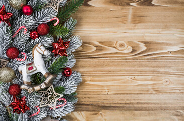 Happy New Year 2022. Beautiful Christmas banner. Fir branches, cones, red berries on a wooden background. Celebrating the Christmas winter holidays. The concept of the beginning of the year.