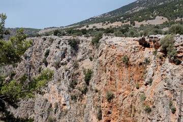 Fototapeta na wymiar Crete - Impressive rocky mountain of the Aradena gorge, the steep walls in Region of Sfakia, Chania. Greece 