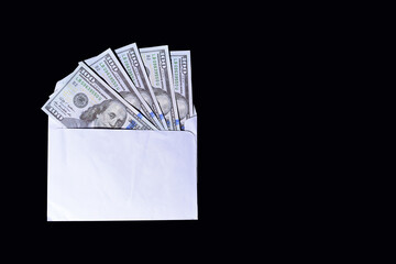 dollars in envelope isolated on black background. bribe concept