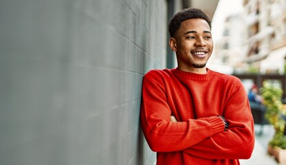 Handsome african american man outdoors standing over gray wall