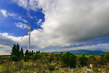 Beautiful sunny summer autumn mountain landscape wind turbines. A winding road in Karacabey Harmanlik, Bursa. Yesil ecological energy is the energy production. Wind farm eco-area