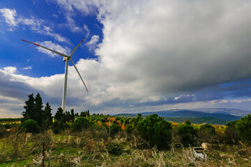 Beautiful sunny summer autumn mountain landscape wind turbines. A winding road in Karacabey Harmanlik, Bursa. Yesil ecological energy is the energy production. Wind farm eco-area