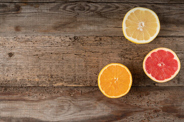 Citruses on a wooden background. Cut fruit. Juicy grapefruit and orange. View from above