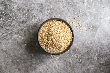 Oat bran in a bowl on gray background