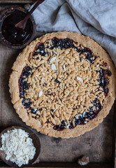 Crumble cake with jam in wooden tray. Homemade streusel jam pie. Top view.