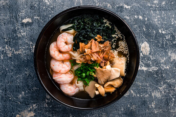 Spicy asian Ramen noodles with Prawns on dark background