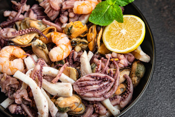 seafood salad fresh mix shrimp, squid, mussel, octopus, prawns meal snack on the table copy space food background 