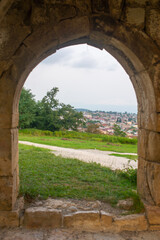 Fototapeta na wymiar view of old kutaisi through the bell tower arch