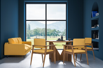 Blue and yellow dining room with sofa