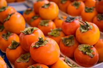 Close-up of ripe persimmons on the counter in the market.