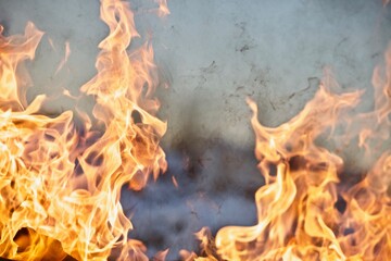 Raging flames of huge fire. Firestorm close up. Burning fire full frame image. Bright inferno flames. Hell fire explosion. Blaze fire texture. Burning bright Bonfire. Intense combustion and heat.