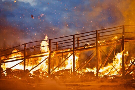 Burning wooden bridge close-up. Raging flames of fire. Firestorm closeup. Wooden structures on fire. Bright inferno flames. Hell fire. Burning constructions background. Intense combustion and heat. © ST-art