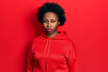Obraz na płótnie Canvas Young african american woman wearing casual sweatshirt skeptic and nervous, frowning upset because of problem. negative person.