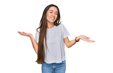 Young hispanic girl wearing casual white t shirt smiling showing both hands open palms, presenting and advertising comparison and balance