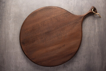 Wood cutting board on stone background top table. Wooden pizza board