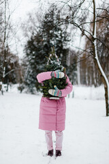 girl holding a Christmas tree