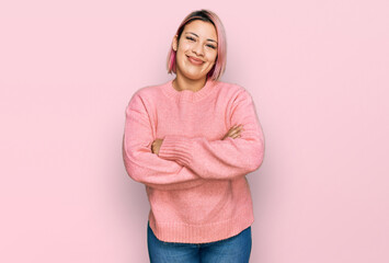 Hispanic woman with pink hair wearing casual winter sweater happy face smiling with crossed arms...