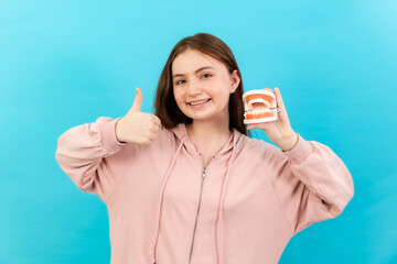 Dental Beautiful smiling of young  woman with retainer braces glad emotion with white teeth increase confidence for healthy on blue background isolated, Happy funny teen girl brush .