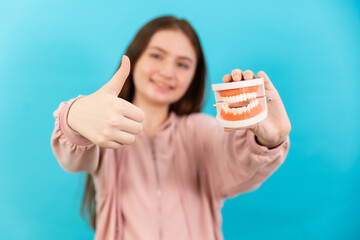 Dental Beautiful smiling of young  woman with retainer braces glad emotion with white teeth increase confidence for healthy on blue background isolated, Happy funny teen girl brush .