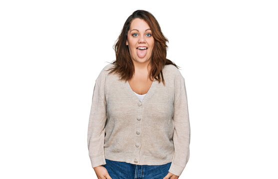 Young plus size woman wearing casual clothes sticking tongue out happy with funny expression. emotion concept.