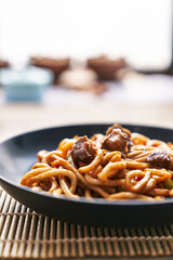  Plate of noodles on a wooden surface