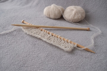 Incomplete knitting project with soft light alpaca silk yarn and bamboo knitting needles