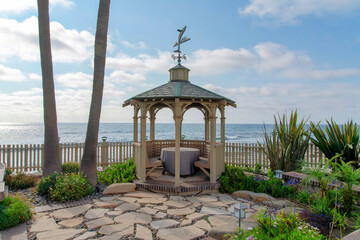 Gazebo with built in seat and table in a beautiful garden at La Jolla, California