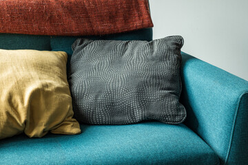 Detail of beautiful stylish armchair with colored pillows indoors design