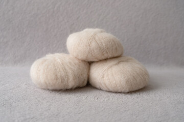 Fototapeta na wymiar Three balls of soft alpaca silk yarn in beige color