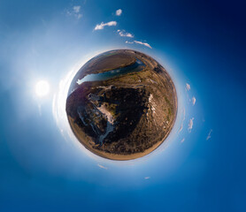 Aerial little planet view of Lyadova christian orthodox monastery in Lyadova village, Travel and vacation, recreation. Autumn sunny day. Dniester river. Vinnytsa region, Ukraine