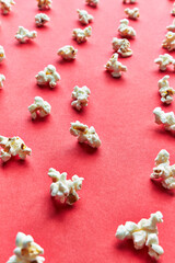  Bunch of salty popcorns on a red background