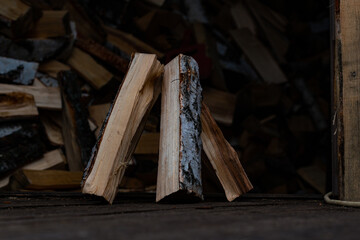 The chopped logs are stacked in a small pile. Harvested firewood, for heating housing in cold winter. Harvesting firewood, in distant Russia.
