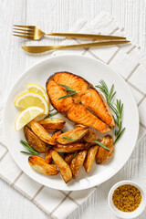 baked salmon steak and potatoes on a plate
