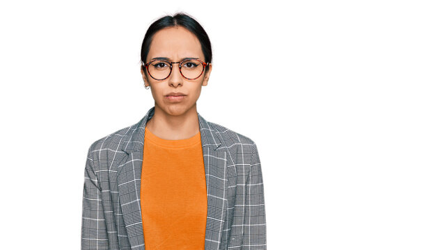 Young hispanic girl wearing business jacket and glasses depressed and worry for distress, crying angry and afraid. sad expression.