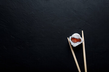 Sushi with tuna salmon rice and chopsticks on an isolated background