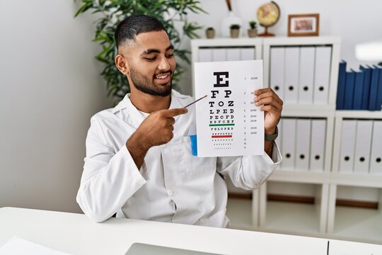 Young arab man holding sneller test at clinic