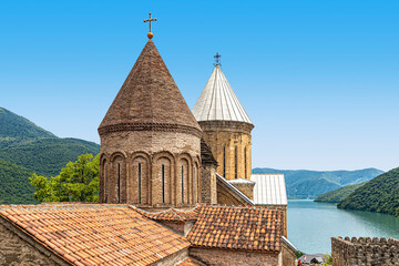 Cone-shaped domes of Ananuri Fortress churches against a blue sky background