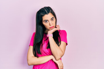 Young hispanic girl wearing casual pink t shirt thinking looking tired and bored with depression...