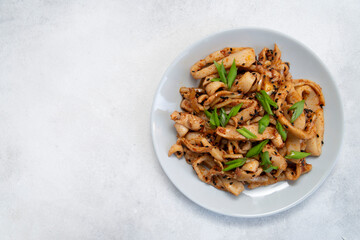 Seafood salad of squid on the grey plate. Macro. On grey background. korean dish.asian dish.