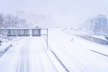 View of a highway in the city covered in snow during heavy snowfall with trapped vehicles. Storm Filomena in Madrid. M-30, Costa Rica area