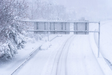 View of a highway in the city covered in snow during heavy snowfall with trapped vehicles. Storm Filomena in Madrid. M-30, Costa Rica area